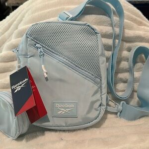 NWT Reebok Ariana Crossbody bag with outside pocket and inside slip pocket.